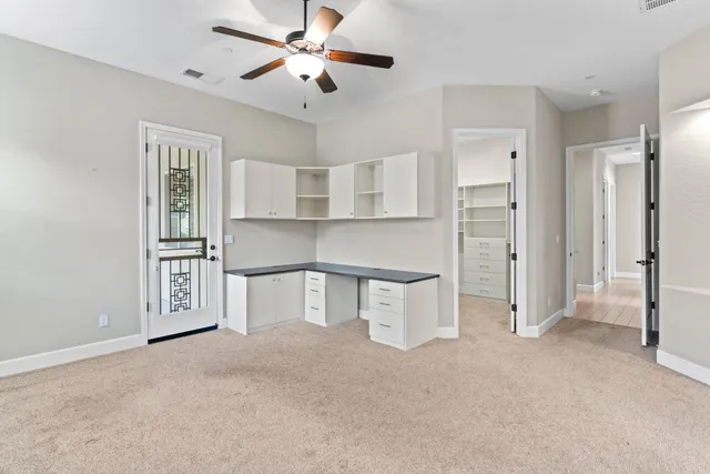 a living room with stainless steel appliances kitchen island granite countertop a refrigerator and cabinets