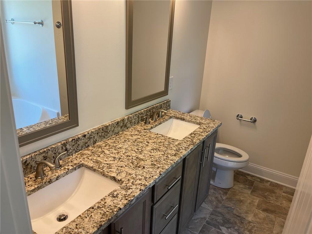 202 Gamel Road Dallas, GA 30157 - Photo 17 of 34 a bathroom with a granite countertop sink and a mirror