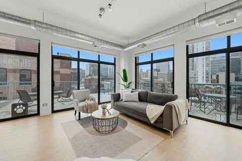 a living room with furniture and floor to ceiling window