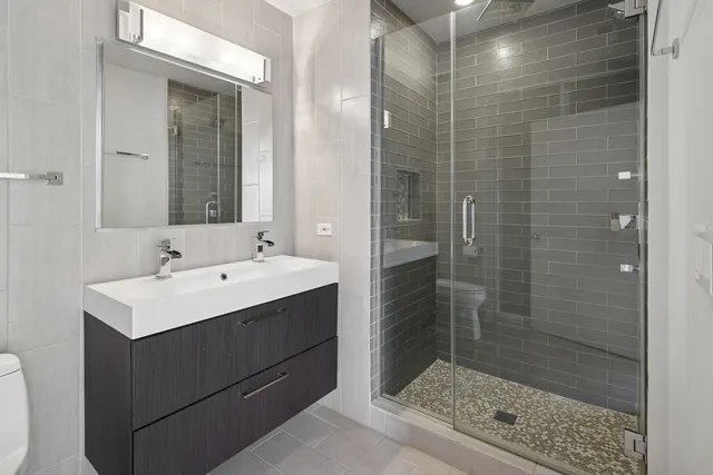 a bathroom with a shower sink and mirror