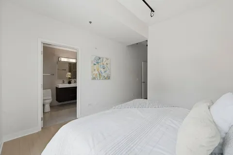 a bedroom with a bed and view of bathroom