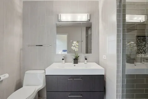 a bathroom with a sink toilet and shower