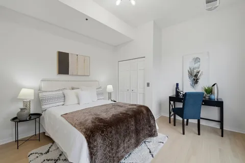 a bedroom with a bed and a table