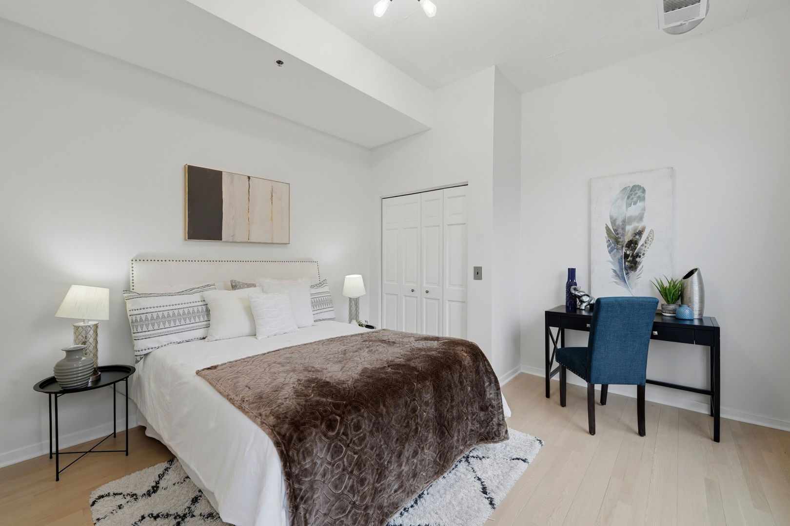 910 West Madison Street, Unit 808 Chicago, IL 60607 - Photo 21 of 37 a bedroom with a bed and a table