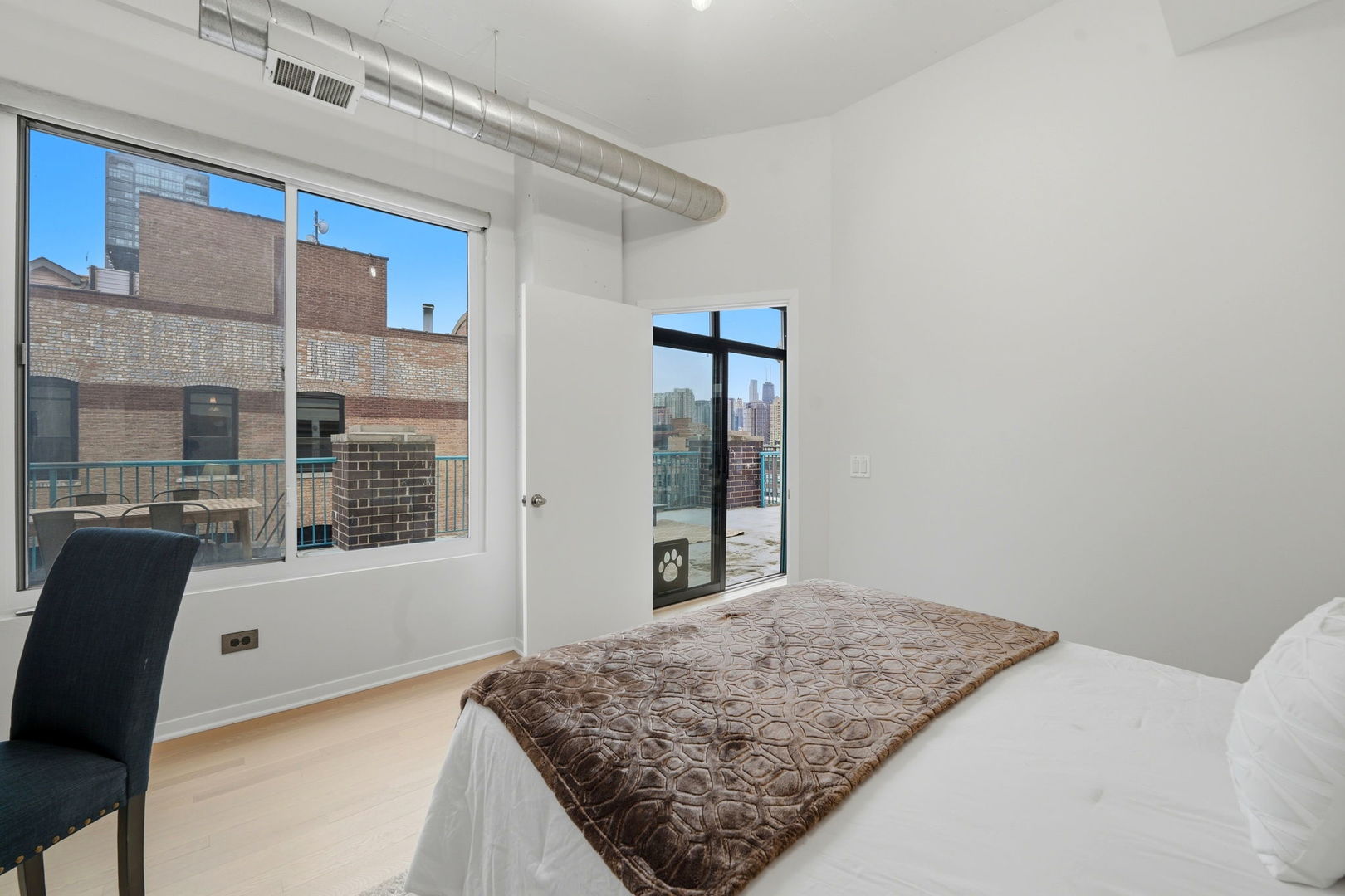 910 West Madison Street, Unit 808 Chicago, IL 60607 - Photo 22 of 37 a bedroom with a bed and glass door