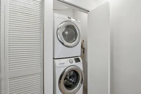 a view of a hallway with washer and dryer