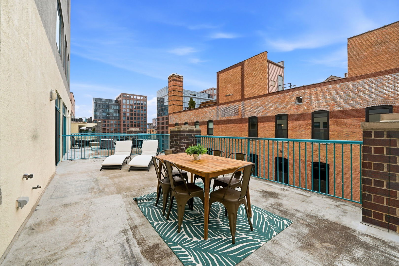 910 West Madison Street, Unit 808 Chicago, IL 60607 - Photo 25 of 37 a view of a roof deck with table and chairs a barbeque with wooden floor and fence
