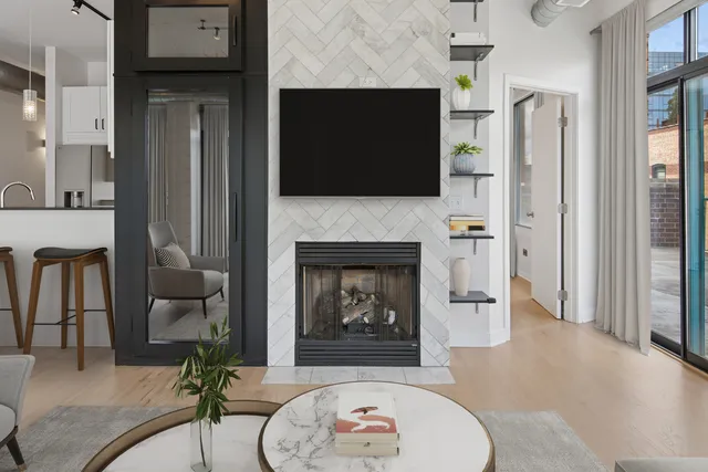 a living room with furniture a flat screen tv and a fireplace