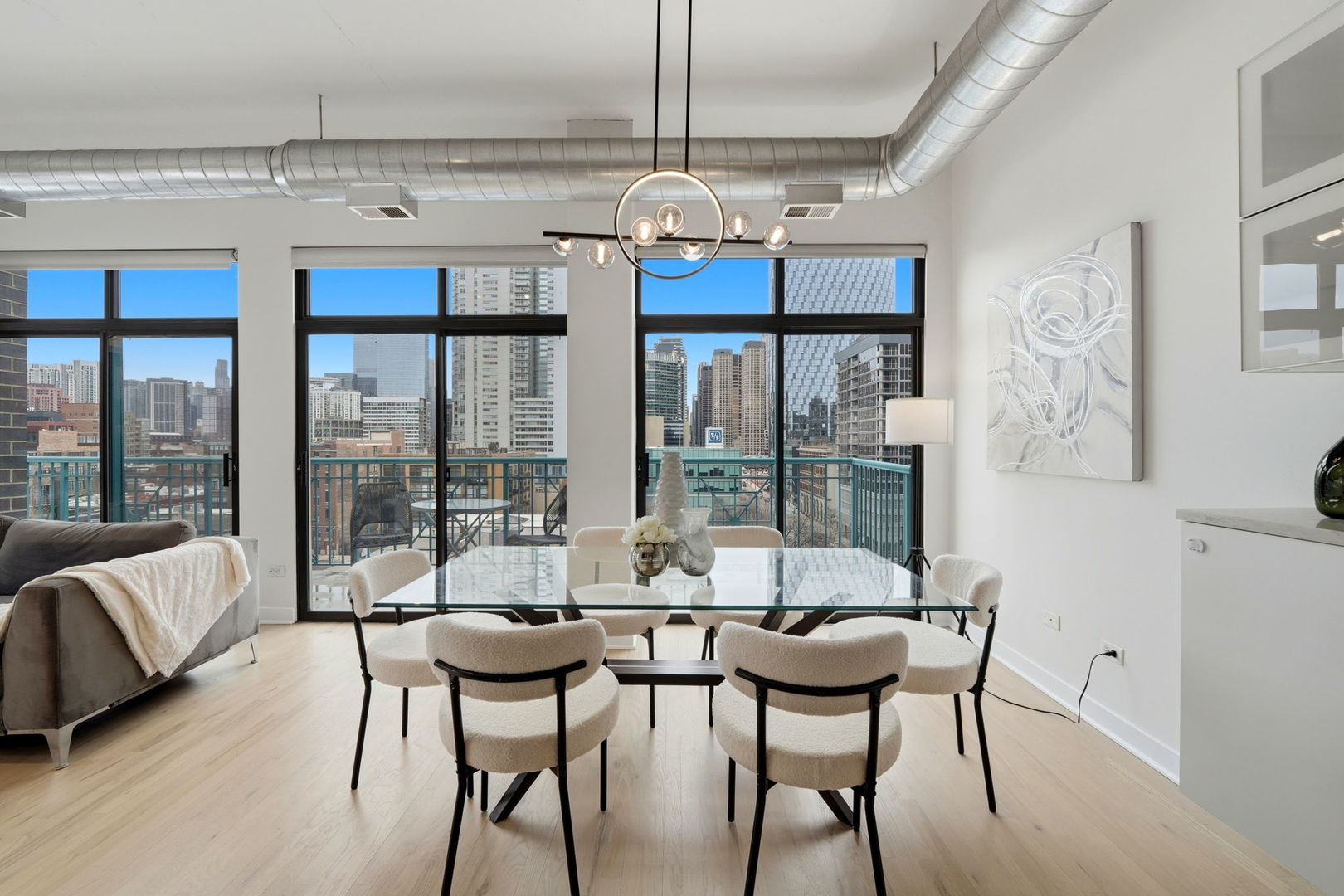 910 West Madison Street, Unit 808 Chicago, IL 60607 - Photo 9 of 37 a view of a dining room with furniture large windows and wooden floor