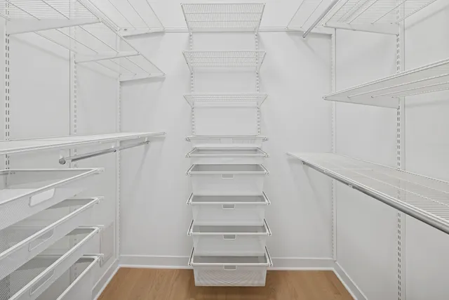 a view of walk in closet with empty racks