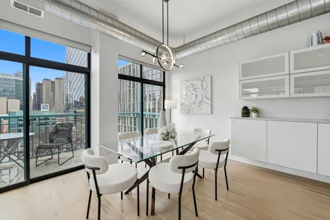 a view of a dining room with furniture window and wooden floor