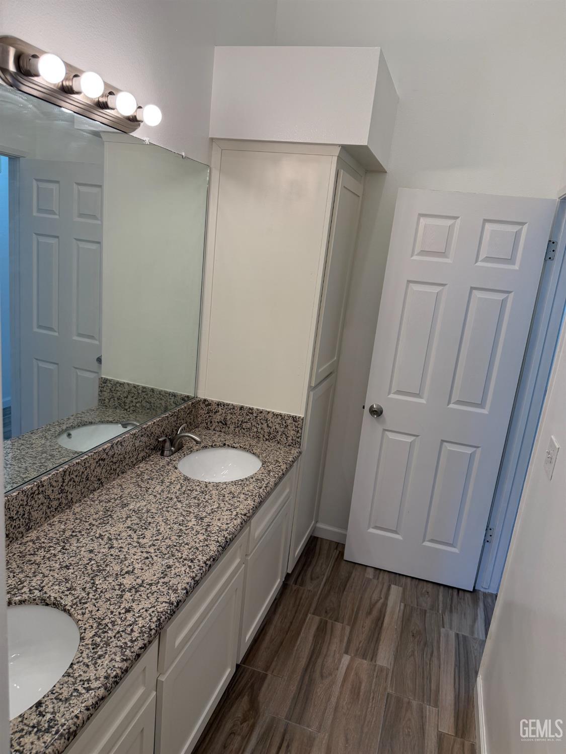 Undisclosed Address Bakersfield, CA 93307 - Photo 3 of 11 a bathroom with a granite countertop sink and a mirror