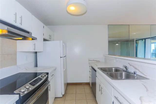 a kitchen that has a sink and a stove
