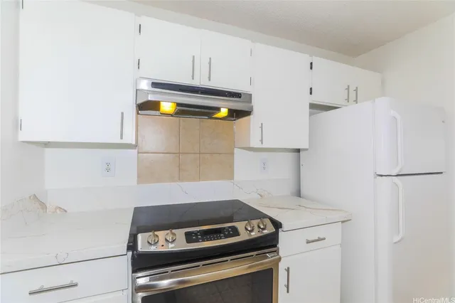 a kitchen with stainless steel appliances a refrigerator and a stove