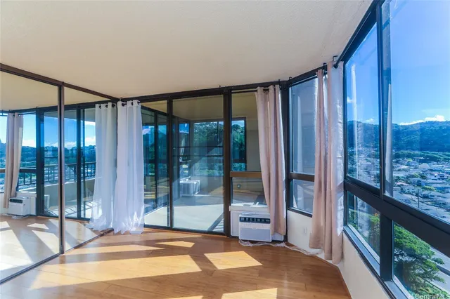 a bedroom with a large window and a balcony