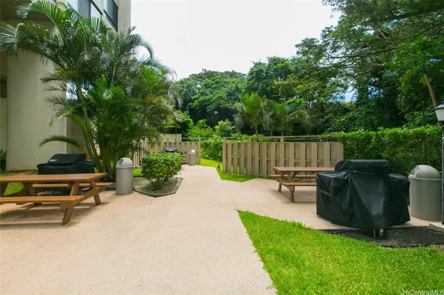a view of a backyard with a bench and a slide