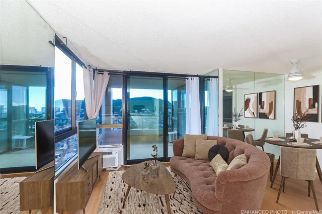a living room with furniture and a floor to ceiling window