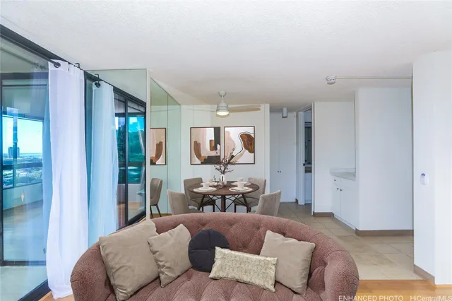 a living room with furniture and a dining table with kitchen view
