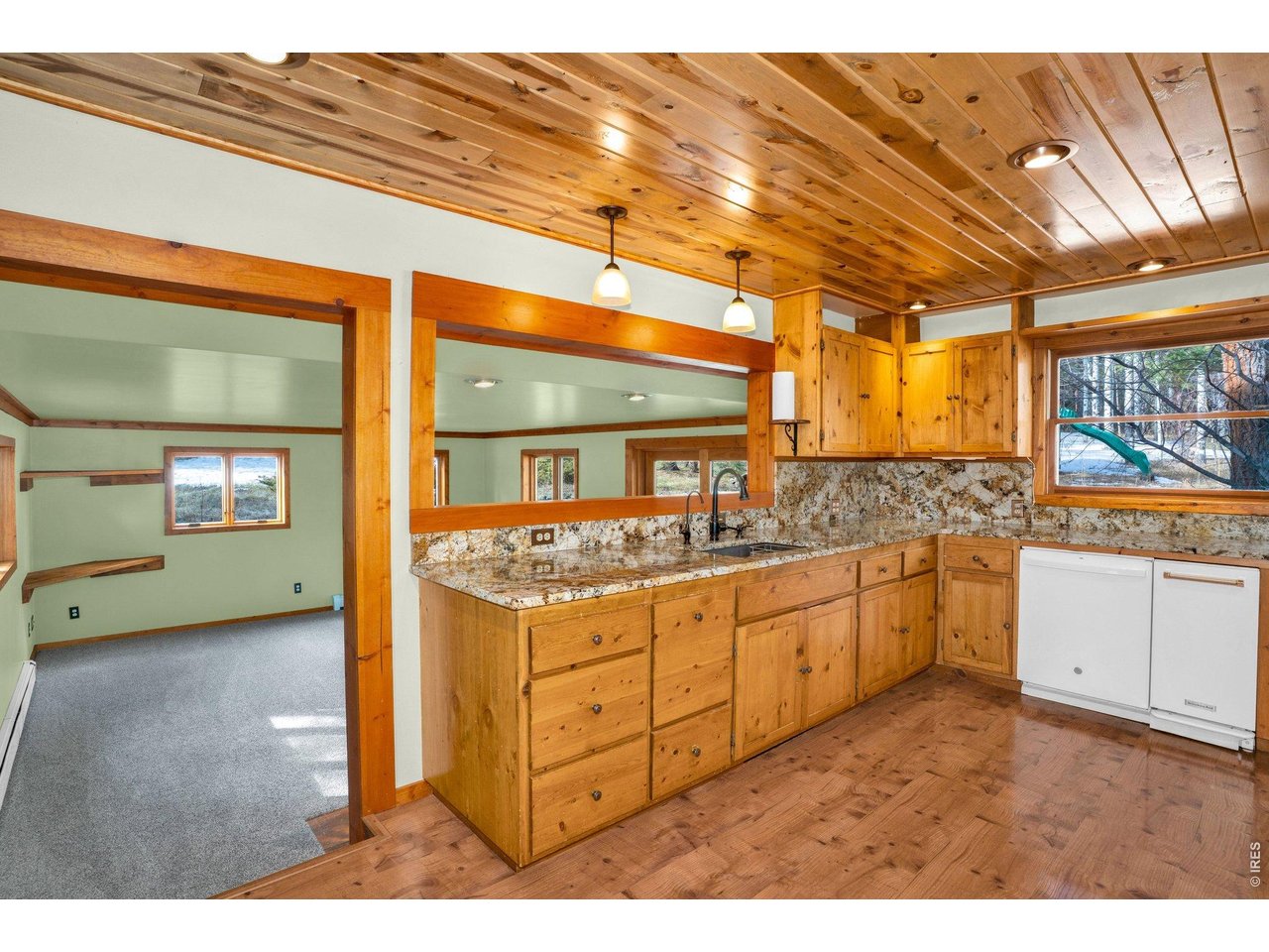 251 Haugen Slide Road Allenspark, CO 80510 - Photo 14 of 42 a kitchen with granite countertop a sink and cabinets