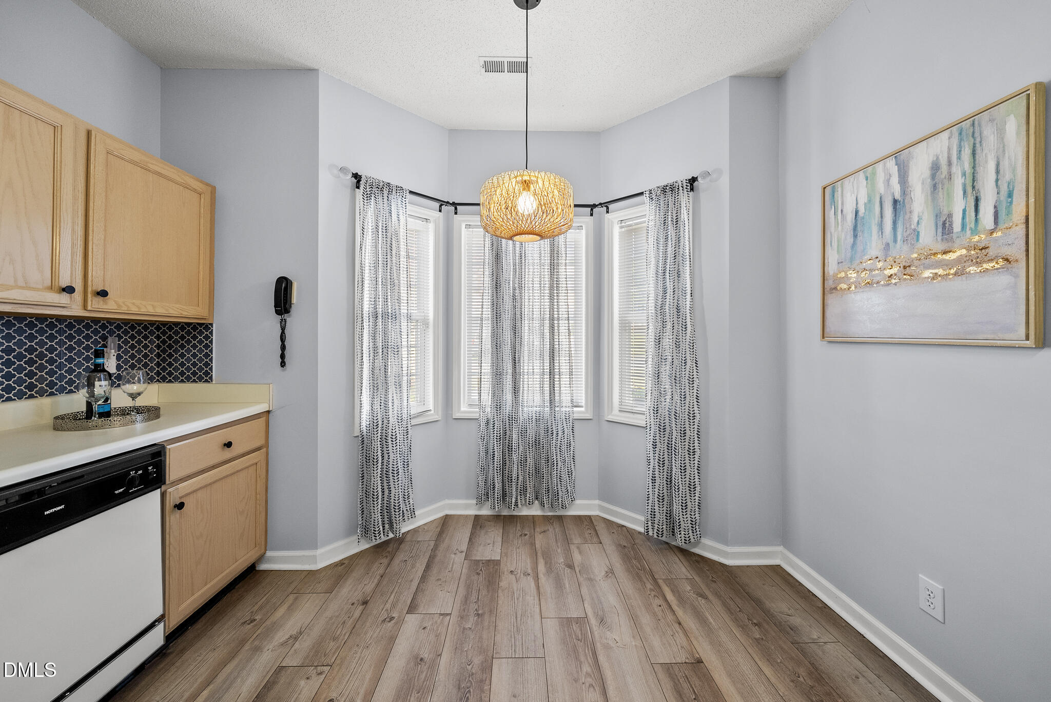 4126 Beaufain Street Raleigh, NC 27604 - Photo 8 of 36 a kitchen with stainless steel appliances granite countertop a sink cabinets and wooden floor