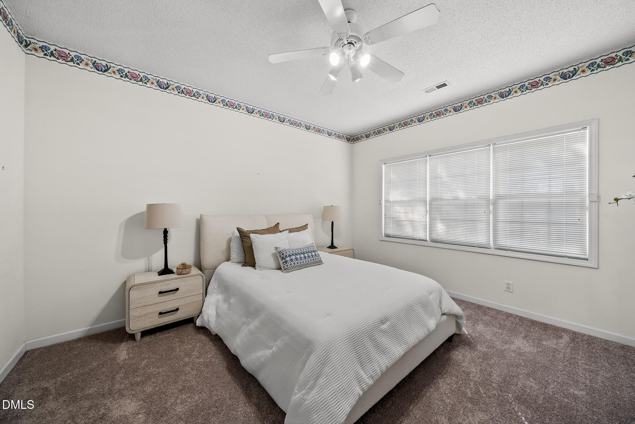 4126 Beaufain Street Raleigh, NC 27604 - Photo 10 of 36 a bedroom with a large bed and a chandelier
