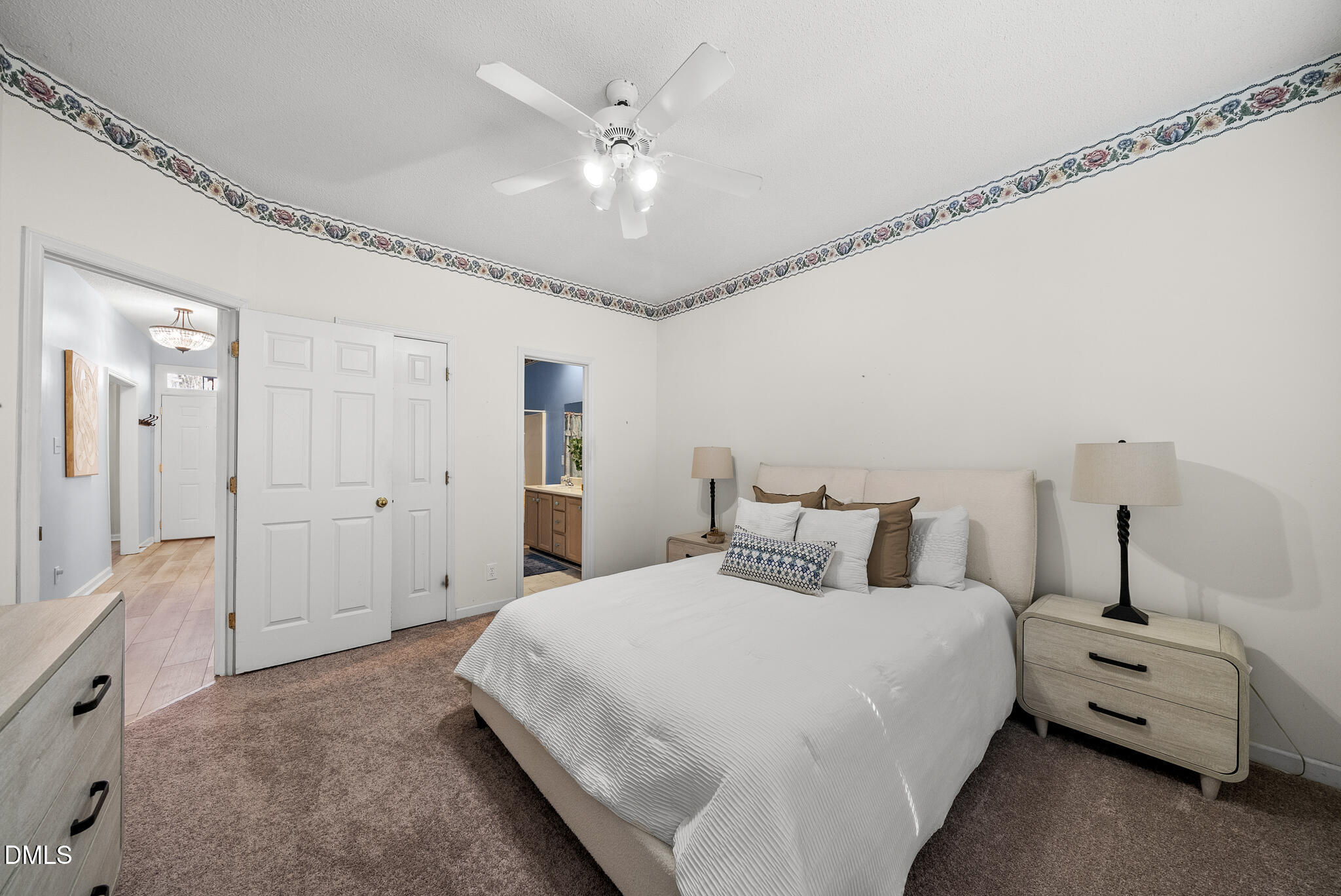 4126 Beaufain Street Raleigh, NC 27604 - Photo 11 of 36 a bedroom with a bed and a chandelier