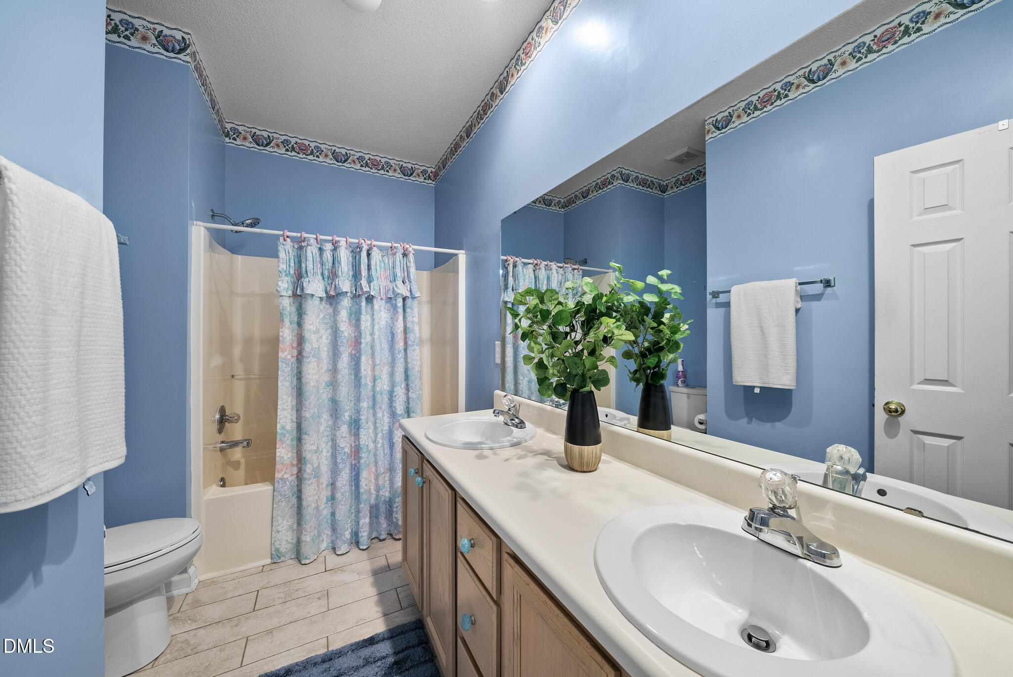 4126 Beaufain Street Raleigh, NC 27604 - Photo 12 of 36 a bathroom with a granite countertop sink and a mirror