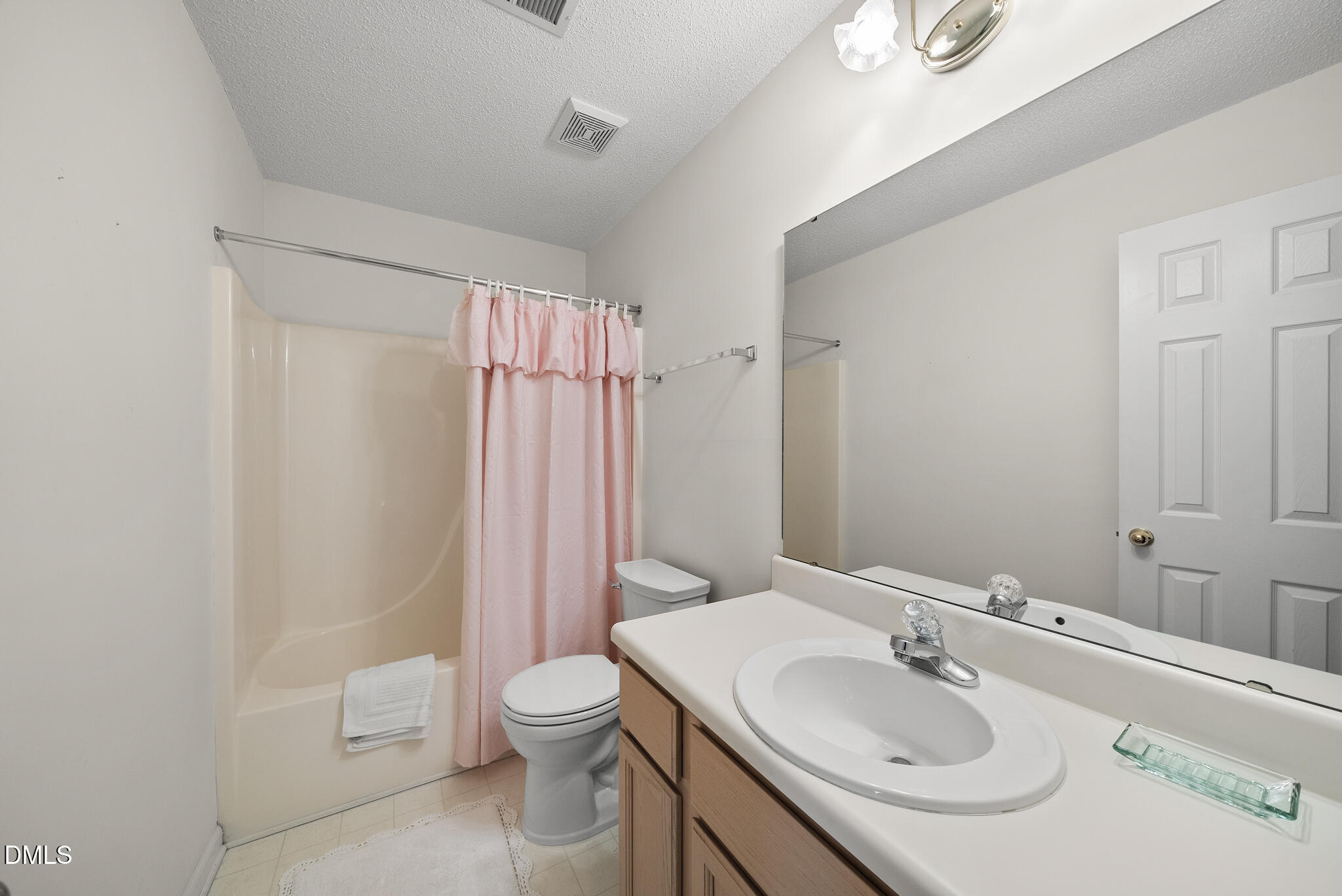 4126 Beaufain Street Raleigh, NC 27604 - Photo 16 of 36 a bathroom with a sink toilet and shower