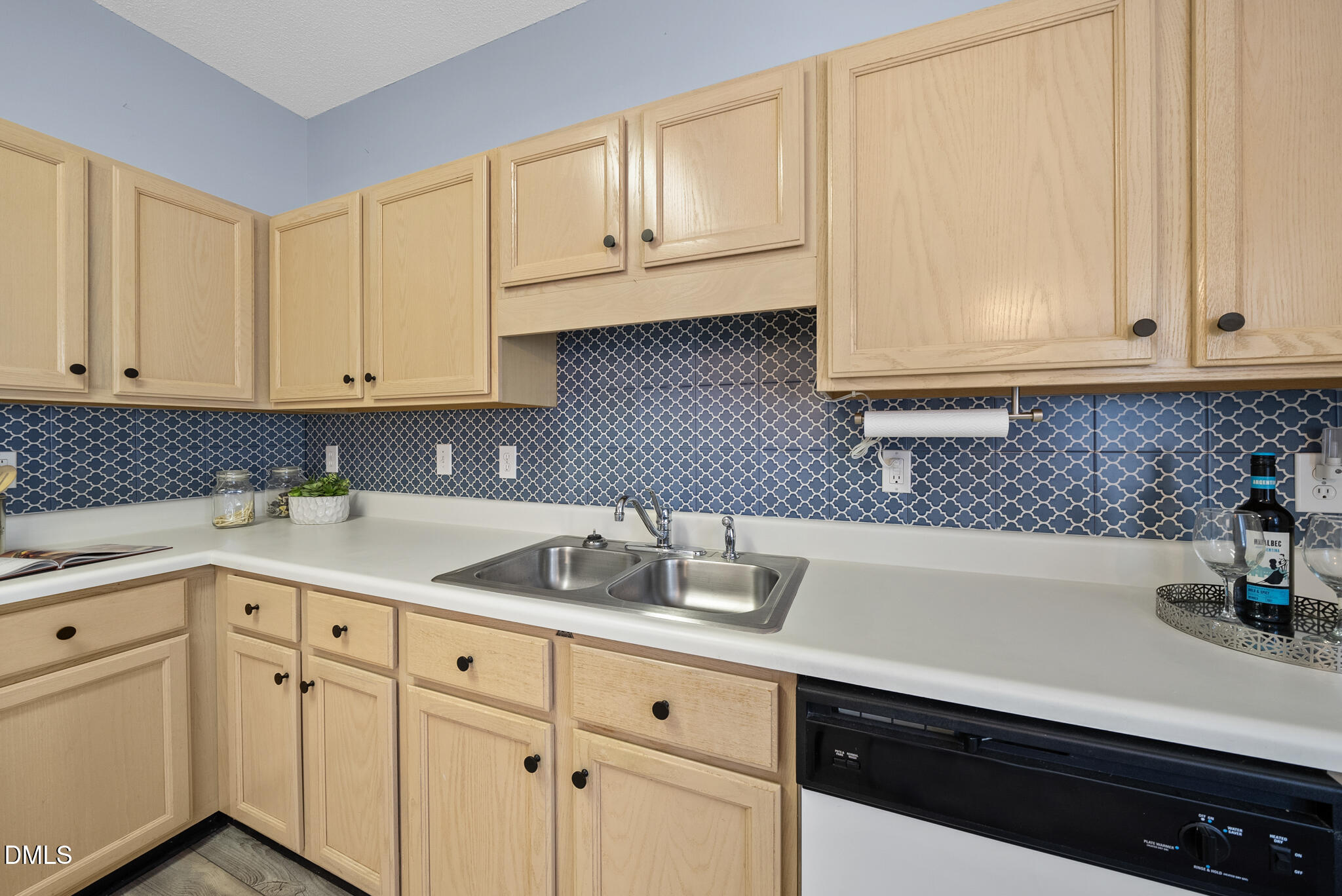 4126 Beaufain Street Raleigh, NC 27604 - Photo 6 of 36 a kitchen with white cabinets and a sink