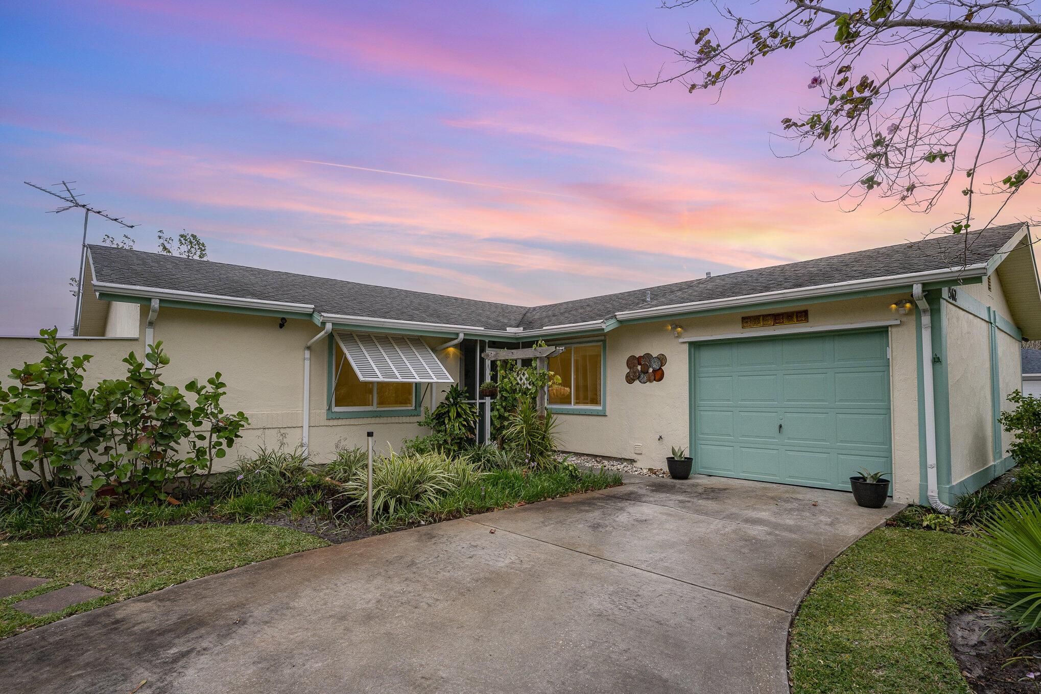 1562 Creel Road Northeast Palm Bay, FL 32905 - Photo 1 of 23 a front view of a house with garden