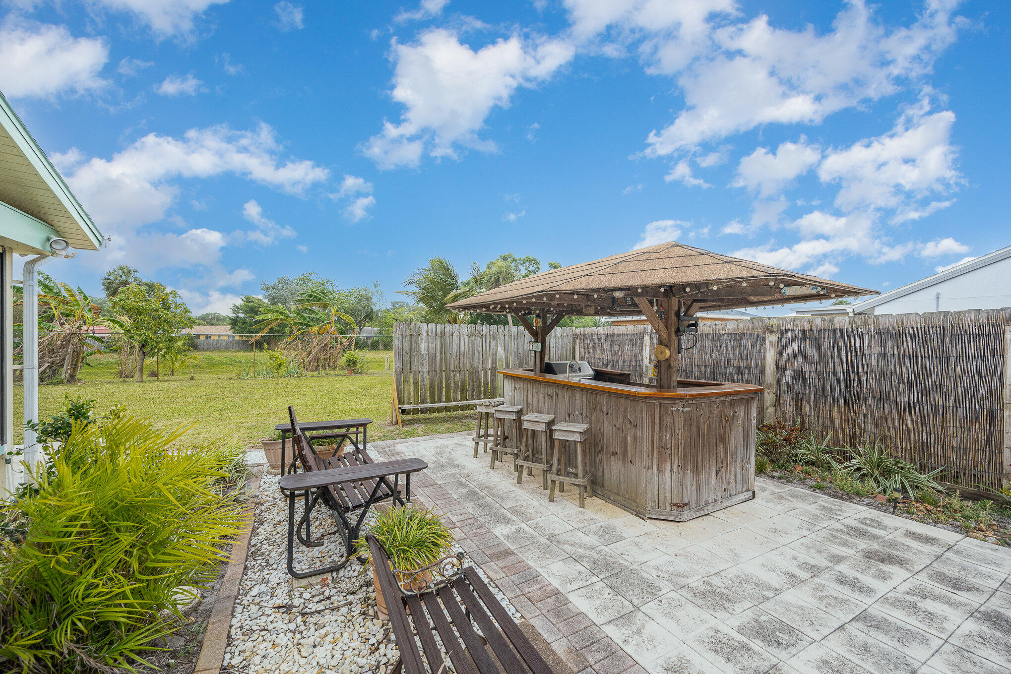 1562 Creel Road Northeast Palm Bay, FL 32905 - Photo 20 of 23 a view of a patio with chairs next to a yard