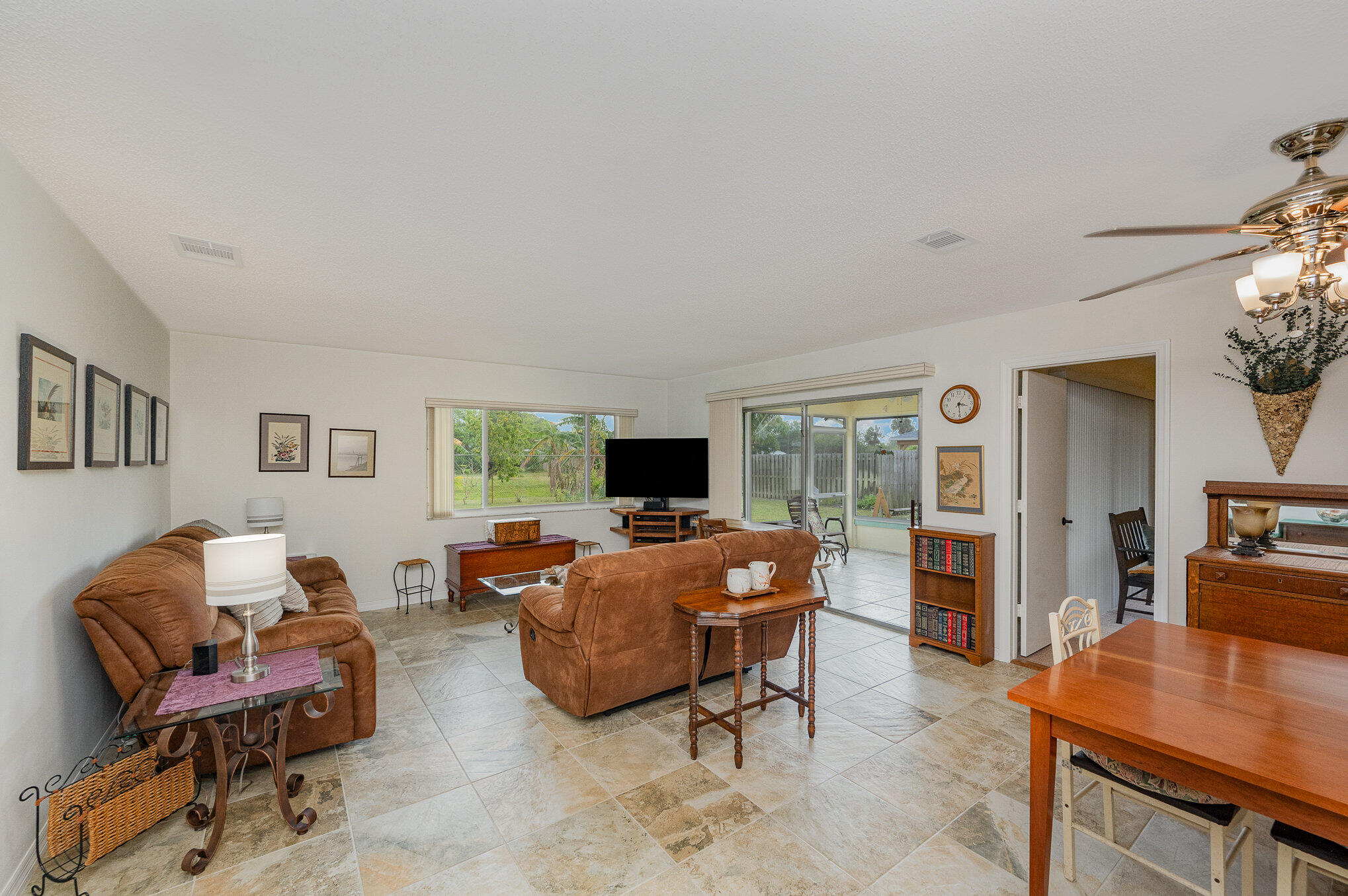 1562 Creel Road Northeast Palm Bay, FL 32905 - Photo 4 of 23 a living room with furniture and a flat screen tv