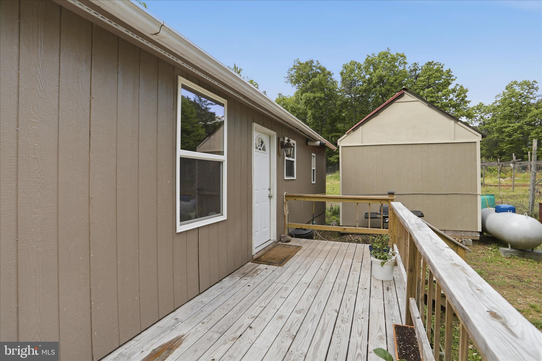 936 Johnny Cake Road Great Cacapon, WV 25422 - Photo 24 of 33 a view of house with backyard and wooden floor