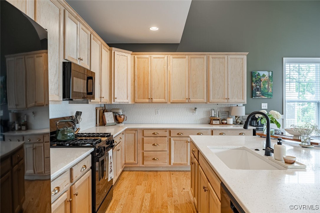 15813 Maclear Drive Midlothian, VA 23112 - Photo 11 of 38 a kitchen with stainless steel appliances granite countertop a sink a stove top oven a refrigerator cabinets and a counter top space