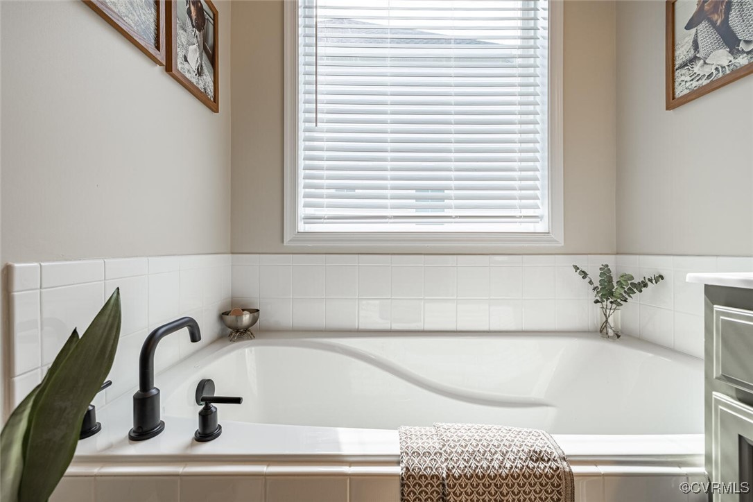 15813 Maclear Drive Midlothian, VA 23112 - Photo 16 of 38 a bathroom with a bathtub and a window