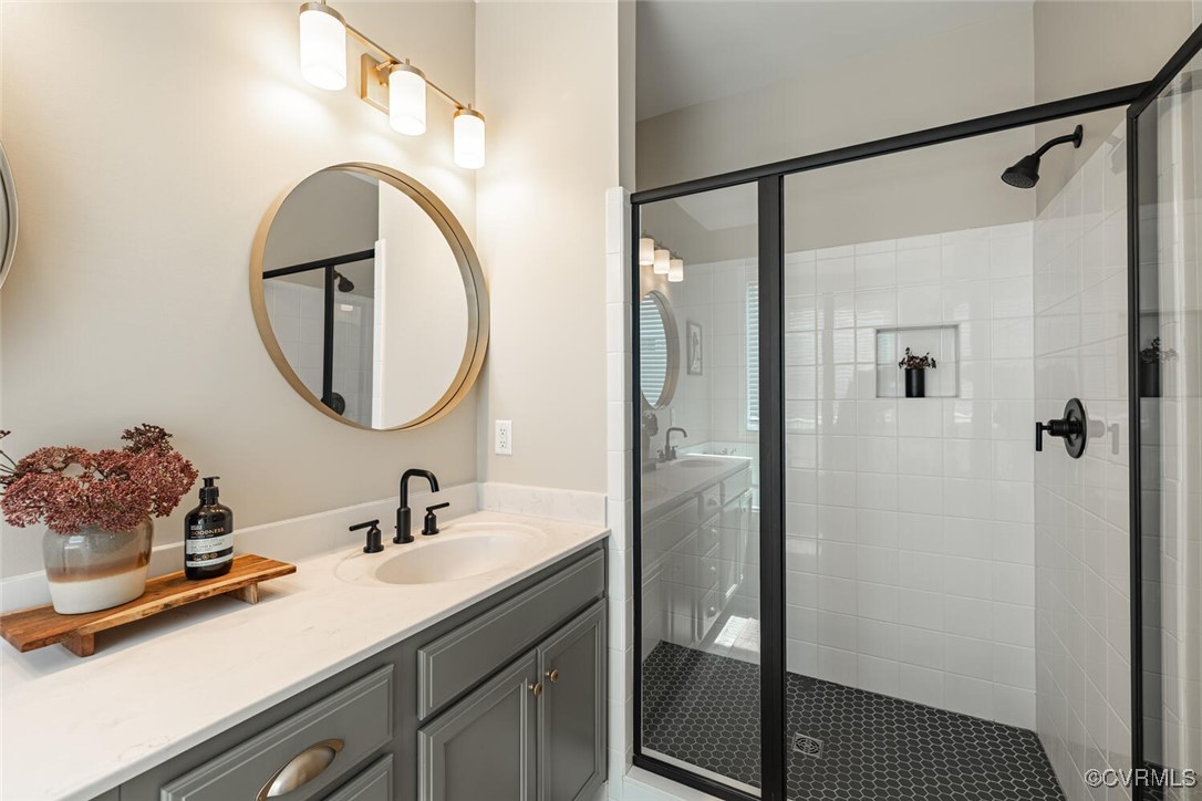 15813 Maclear Drive Midlothian, VA 23112 - Photo 17 of 38 a bathroom with a sink a mirror a vanity and a shower
