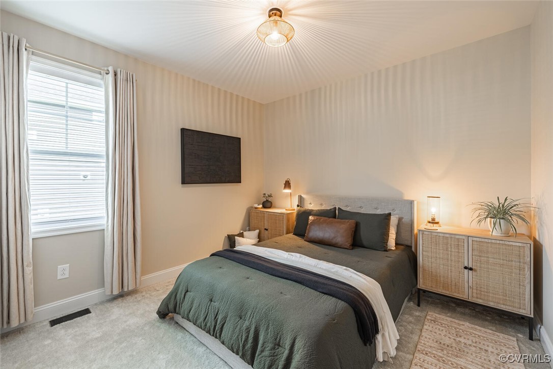 15813 Maclear Drive Midlothian, VA 23112 - Photo 22 of 38 a bedroom with a bed and a flat tv screen