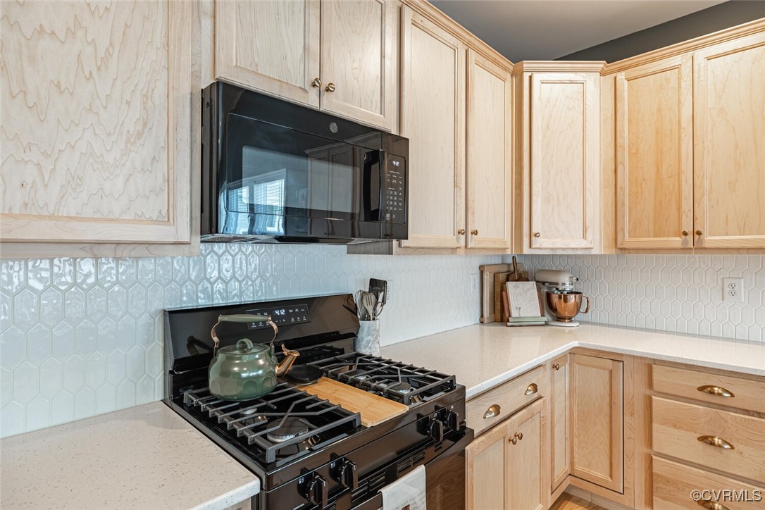 15813 Maclear Drive Midlothian, VA 23112 - Photo 9 of 38 a kitchen with stainless steel appliances granite countertop white cabinets and a stove top oven