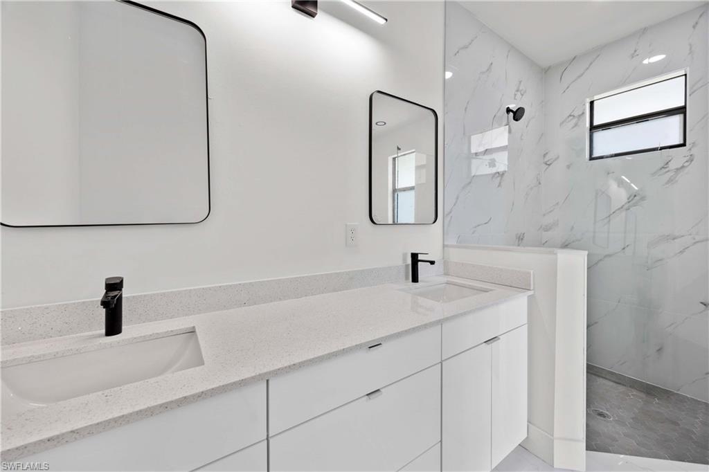 228 Connecticut Road Lehigh Acres, FL 33936 - Photo 12 of 21 a bathroom with a sink and a mirror