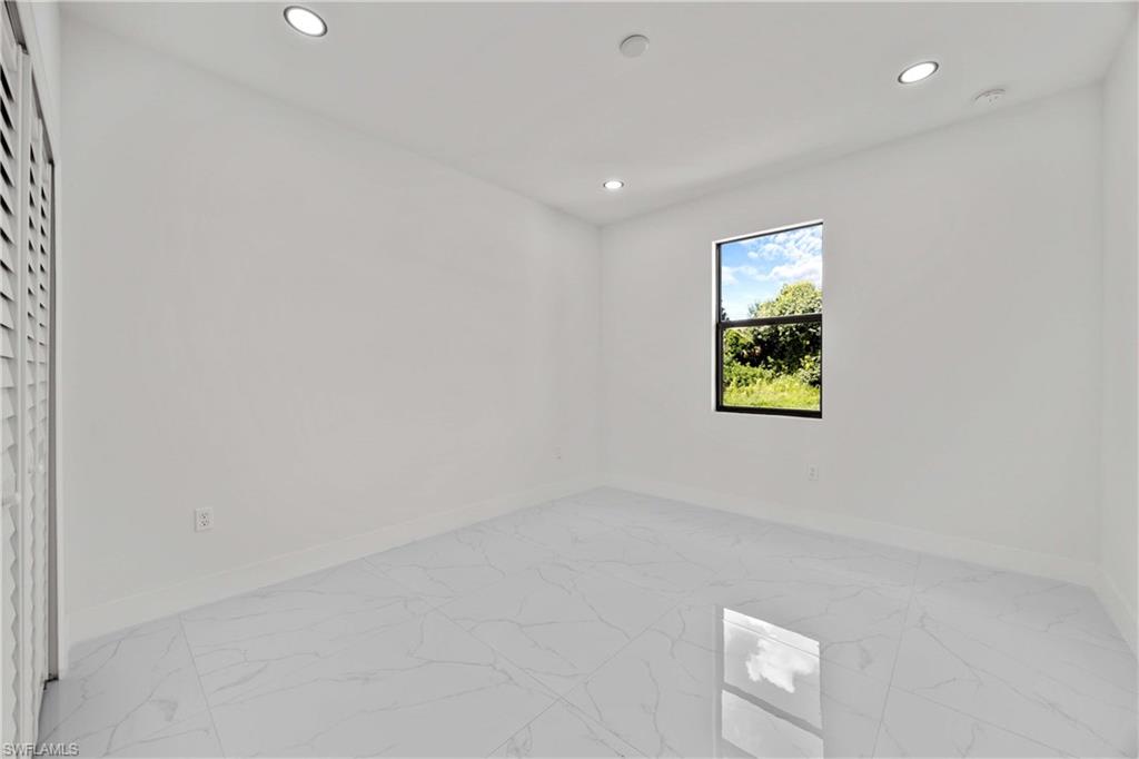 228 Connecticut Road Lehigh Acres, FL 33936 - Photo 13 of 21 an empty room with a window