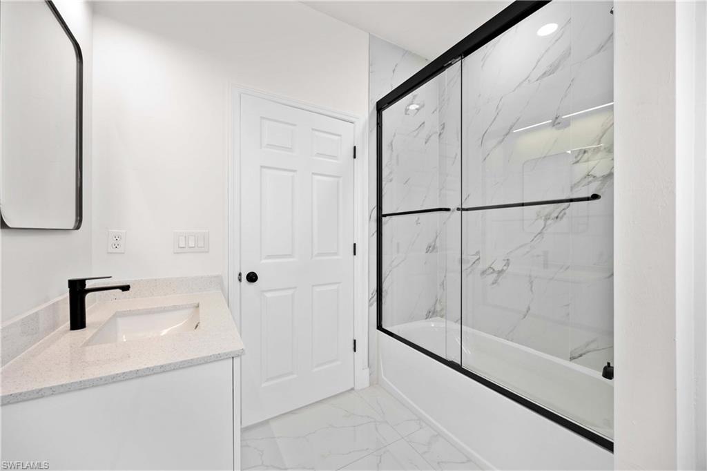 228 Connecticut Road Lehigh Acres, FL 33936 - Photo 15 of 21 a bathroom with a shower and a sink