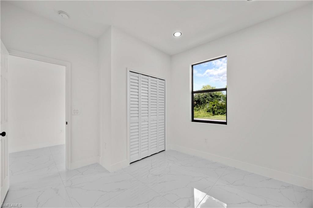 228 Connecticut Road Lehigh Acres, FL 33936 - Photo 16 of 21 an empty room with windows