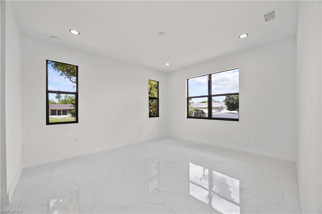 228 Connecticut Road Lehigh Acres, FL 33936 - Photo 10 of 21 a view of an empty room with a window