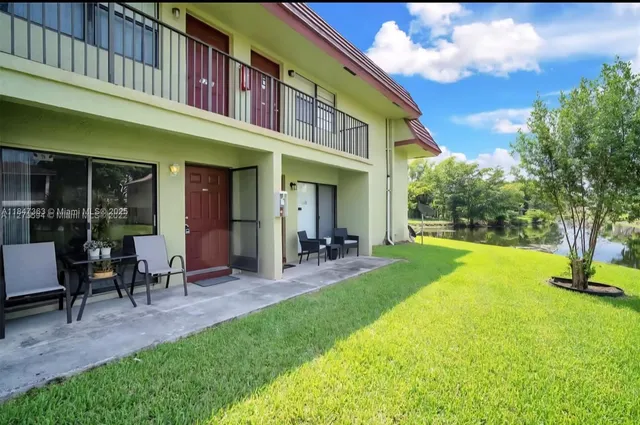 a view of a house with a yard patio and a slide