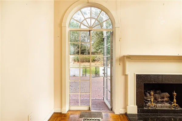 a living room with a fireplace and a window