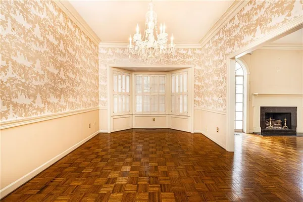 a view of an empty room with window and fire place
