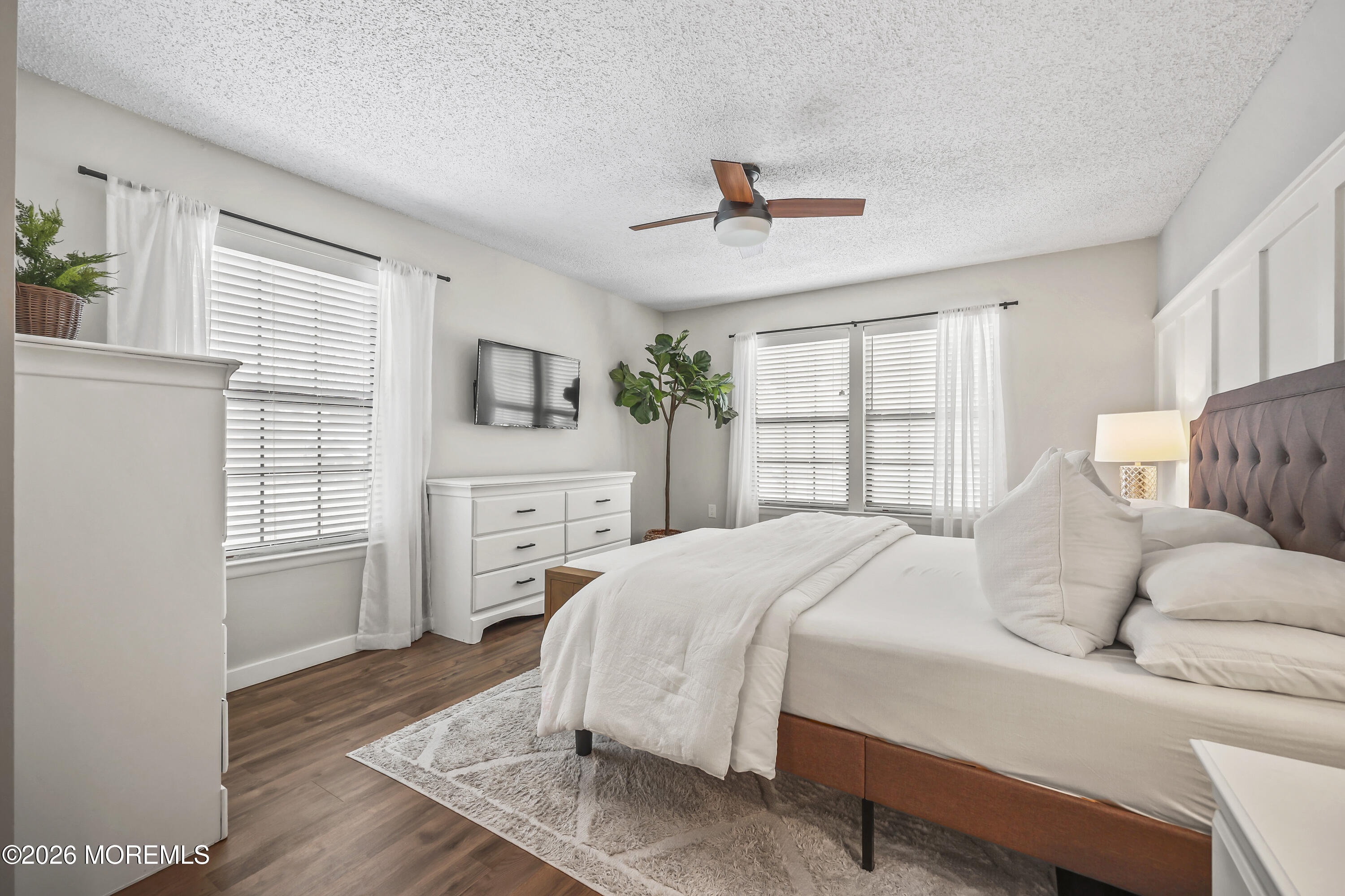 710 Ivy Court Jackson, NJ 08527 - Photo 12 of 21 a spacious bedroom with a bed a couch and a window with wooden floor