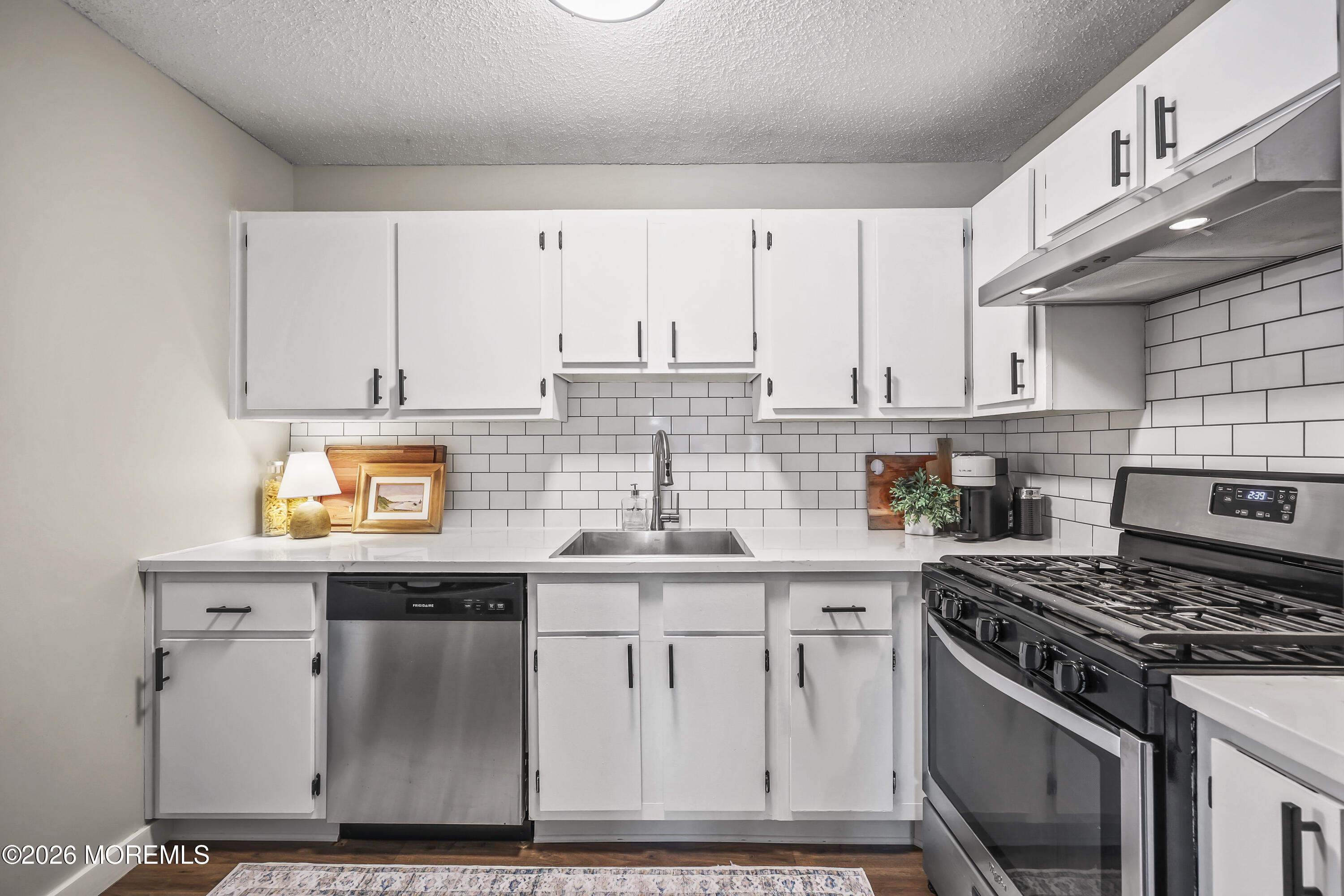 710 Ivy Court Jackson, NJ 08527 - Photo 5 of 21 a kitchen with stainless steel appliances granite countertop a stove a sink and white cabinets