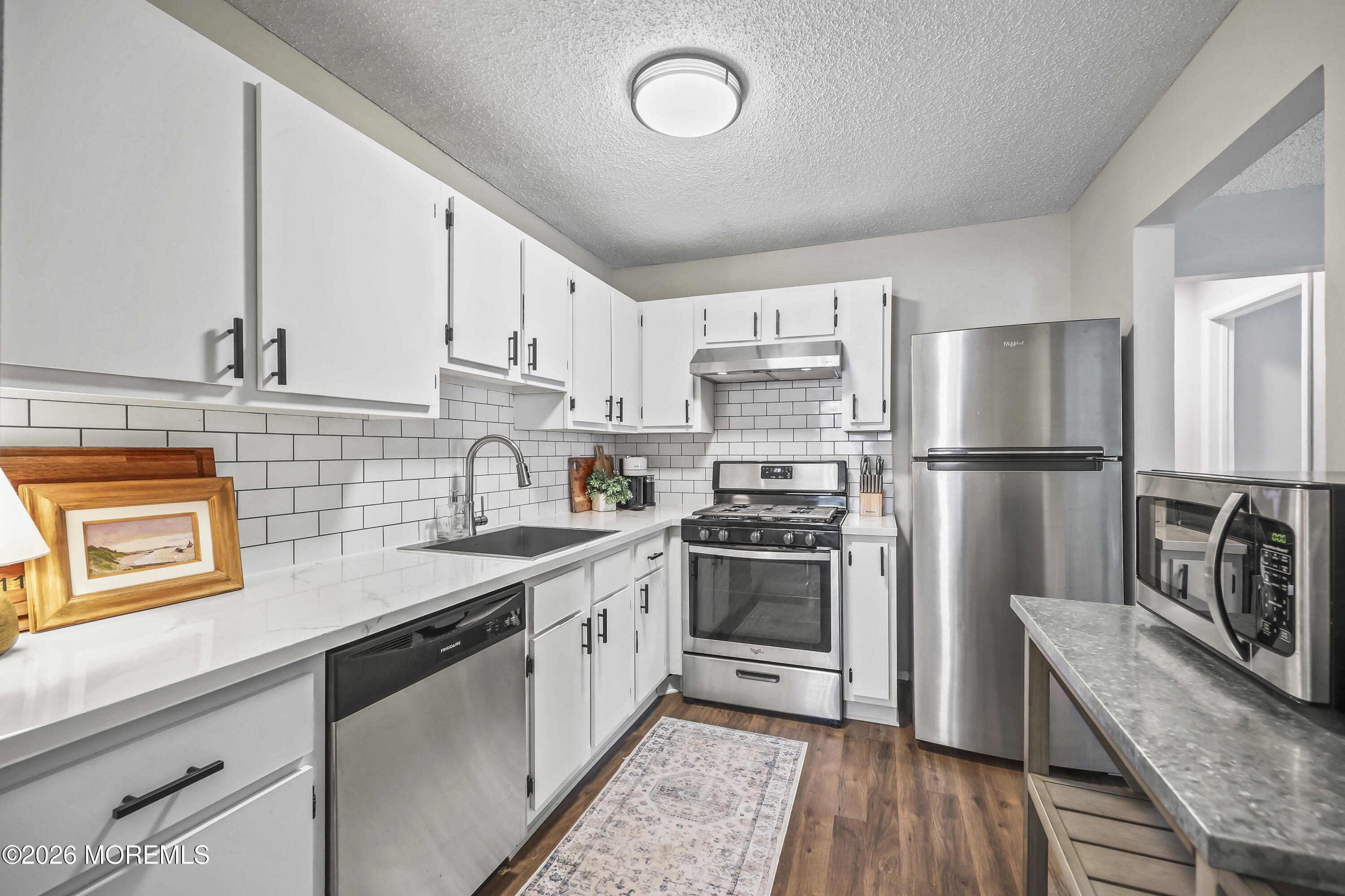 710 Ivy Court Jackson, NJ 08527 - Photo 6 of 21 a kitchen with stainless steel appliances granite countertop a stove a sink dishwasher a refrigerator and cabinets with wooden floor