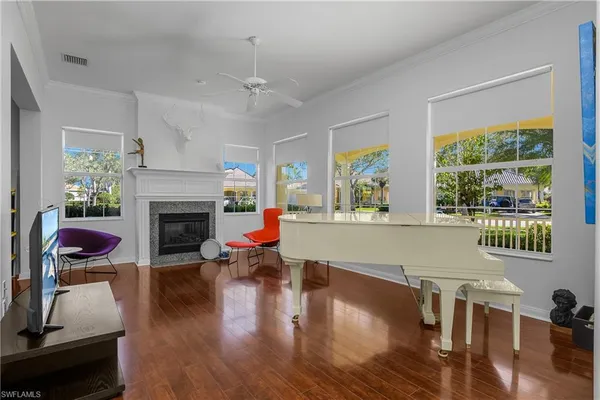 a living room with furniture fireplace and window